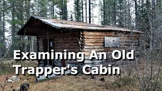 Examining An Old Trapper's Cabin