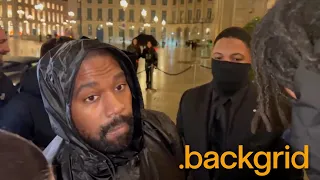 Kanye West takes a moment to greet fans outside his car in Paris, France