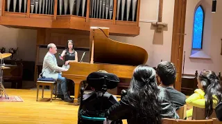 Alejandro performing on the piano while singing