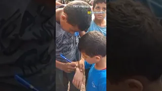 Palestinian children’s names inked on their skin in preparation for Israeli attacks