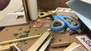 A messy craft desk equals a miniature house being built. Rolife kit. Part 4.