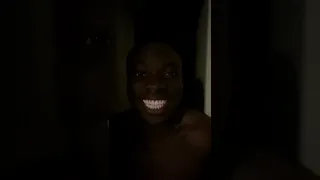 Black man laughing in the dark