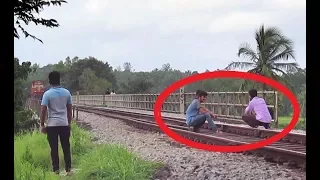 Taking photos in front of speeding train : Stupid stunts on Railway track!!