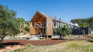 Modern Family House Design With Black Concrete Panels on a Slightly Sloped Piece of Farmland