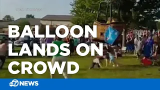 Hot air balloon hits spectators during hard landing