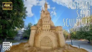 A quadcopter flight around the sculptures at the sand sculpture festival 4k