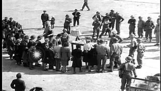 Civilians view a table displaying Nazi atrocities: Items made of human skin at Bu...HD Stock Footage