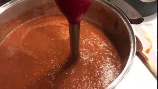 Pureeing tomato sauce with an immersion blender