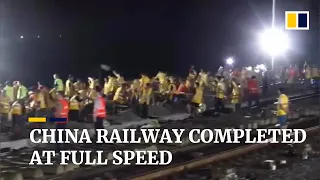 1,000 Chinese railway workers race to finish track in overnight operation