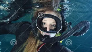 Intelligent girl in latex full face gas masks and scuba diving gear dresses