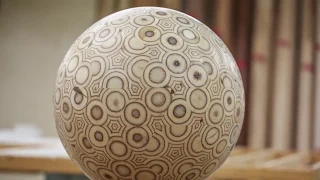 Guy makes a big ball out of plywood