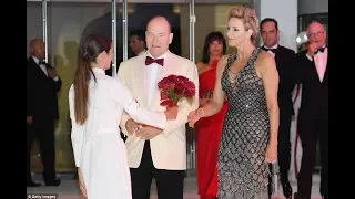 Princess Charlene holds crimson blooms for her stunning entrance to 70th Monaco Red Cross Ball with