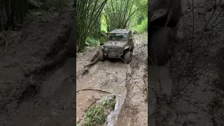 Off road in big rain mud trail with Jeep Wrangler JL