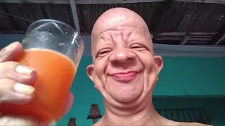 Лысый мужик пьет апельсиновый сок