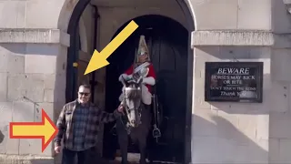 DISRESPECTFUL TOURISTS REFUSE TO RELEASE HOLD ON HORSE’s reins.