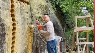 Man drills a hole in a mountain to create a house