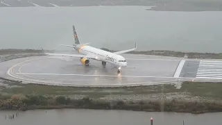 Condor powerful take off at Corfu during a rainy morning, filmed from a hotel balcony