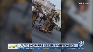 Firefighters rescue woman from auto shop fire