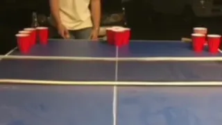 drunk guy playing beerpong and falling down