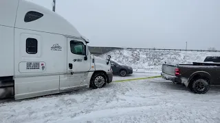 2019 Dodge Ram 3500 pulling a loaded semi truck out of snow