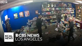 Security camera footage shows struggle with armed robber at Colton collectible store