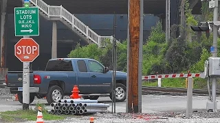 A Truck Running The Gates In Front Of A Train