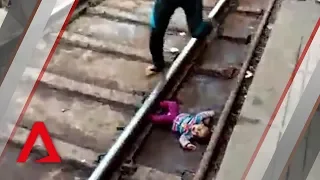 Baby falls onto train tracks in India