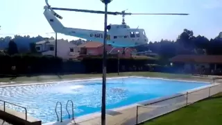 Helicopter refills its water bucket from a public swimming pool
