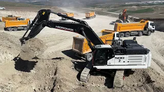 Hidromek Excavator Loading soil onto trucks.