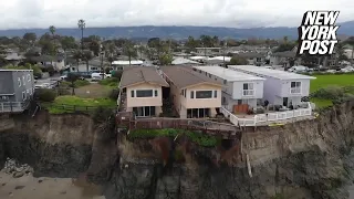 Multimillion-dollar homes teetering on edge of California cliff after landslide, footage shows