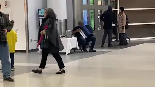 Accordion player plays Game of thrones at the airport