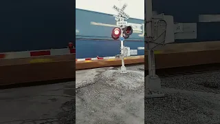 Fast CSX double stack train goes by the railroad crossing December 30th 2022