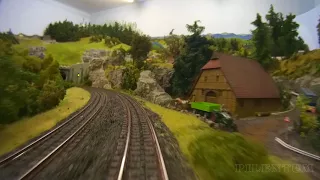 Cab ride on a model railroad layout with hidden railway station in HO scale