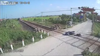 Motorcyclist gets knocked off bike by a level crossing barrier's
