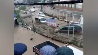 Dramatic video footage shows vehicles being swept downstream by fast moving floods