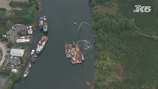 Abandoned boat being removed from water