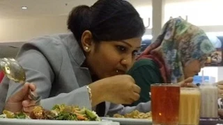 Indian Lady eating with her hands, Its a cultural thing.