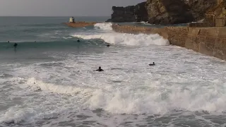Bodyboarders making the most of the high tide at Portreath