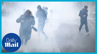 Paris protesters kick around tear gas cannisters fired by police