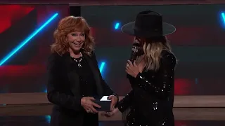 Reba Invites Lainey Wilson to Become an Opry Member