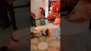 Groom removing magic garter to his wife while dancing