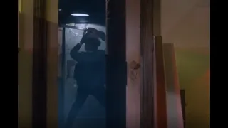 leatherface heads back to the metal door and tries to dance it open