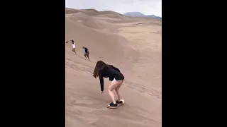 Chris Watts: Nikki Kessinger sand boarding in the Great Sand Dunes