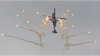 Boeing AH-64D Apache helicopter fires its flares during a demo @ Beek for Speed 2013 event