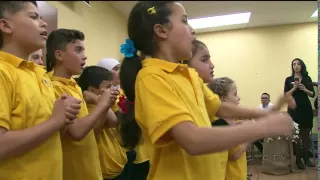 Syrian refugees singing thanks merci Canada