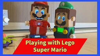 Playing with a Lego Super Mario set.