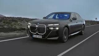 2022 BMW 740i G70 M Sport in Frozen Deep Grey metallic - driving with lights on