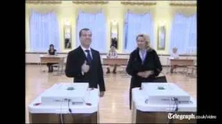 Russian President Dmitry Medvedev and Prime Minister Vladimir Putin vote