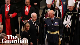 Joe Biden waits for seat after apparent late arrival at Queen’s funeral