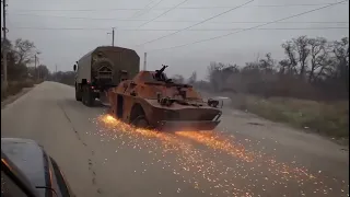 Ukrainian Forces drags a dead Russian BRDM-2 amphibious scout vehicle that's seen better days